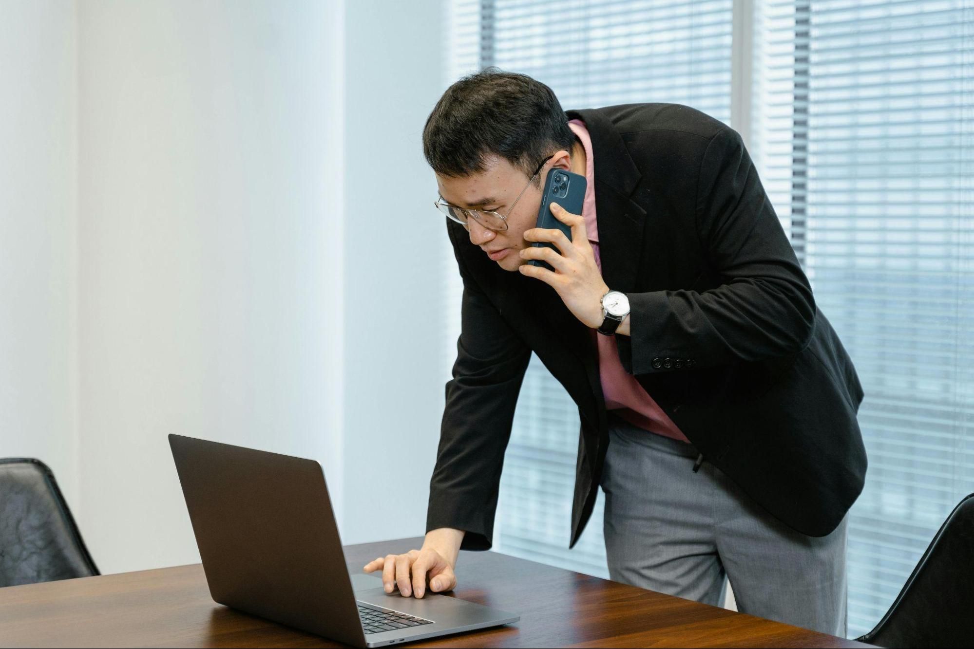 A recruiter on a phone call interview, taking notes of the candidate’s response. 