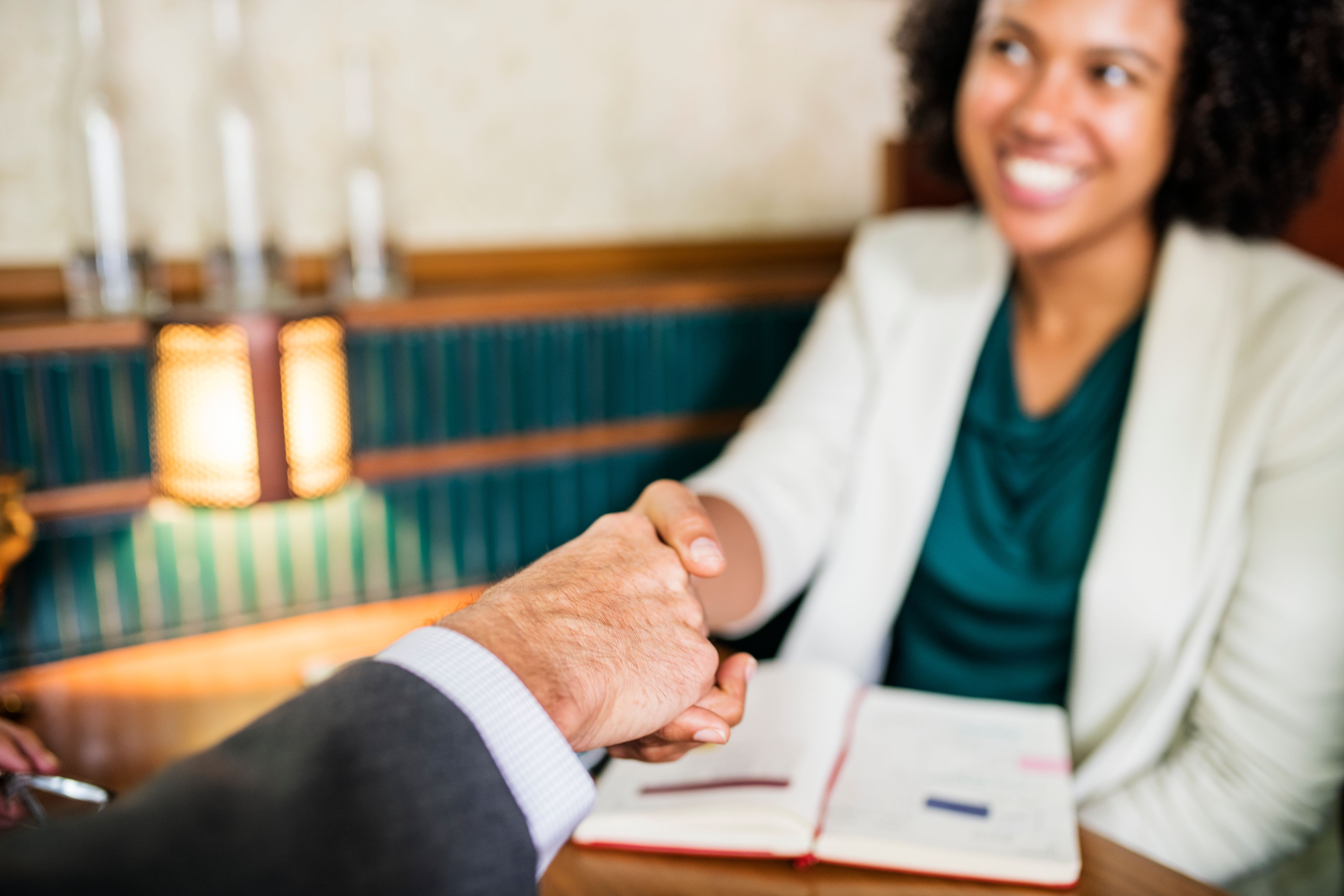 Women shaking hands with business partner